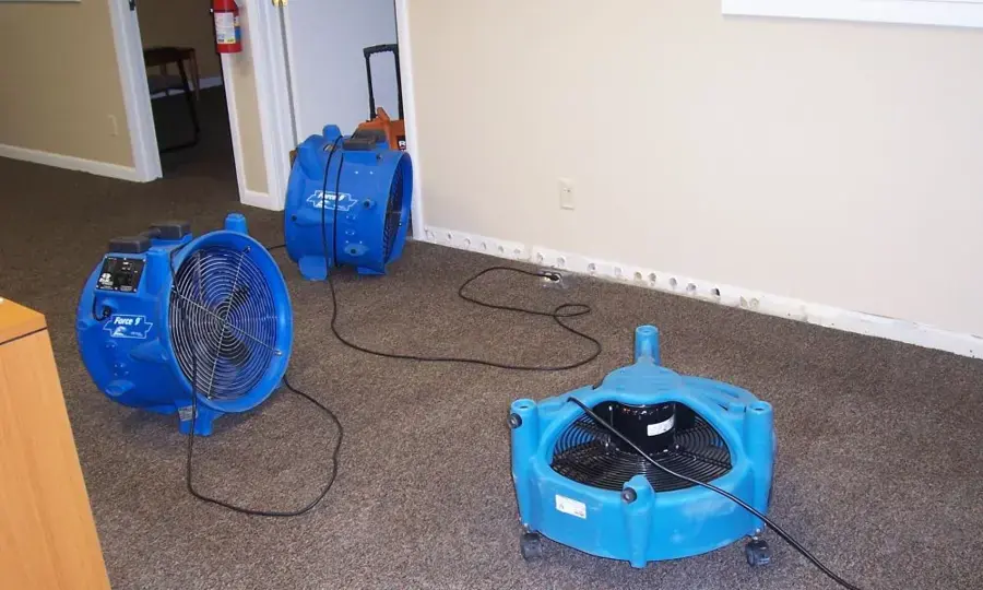 Air movers and drying equipment running in a room of a Treasure Island home during water damage restoration