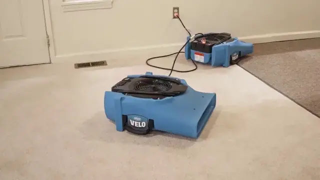 Drying equipment running in a room of a home in Pinellas Park, FL, with air movers on the floor.