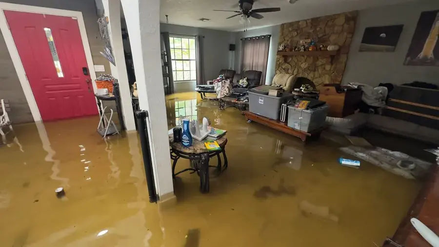 Floodwater standing across a living room after a storm